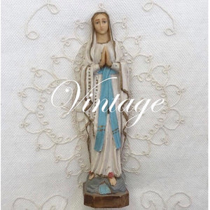 Vintage collection. Image is of a vintage, french, cream jug, with a bunch of flowers in. Behind this is a mannequin with a vintage, white shawl on.